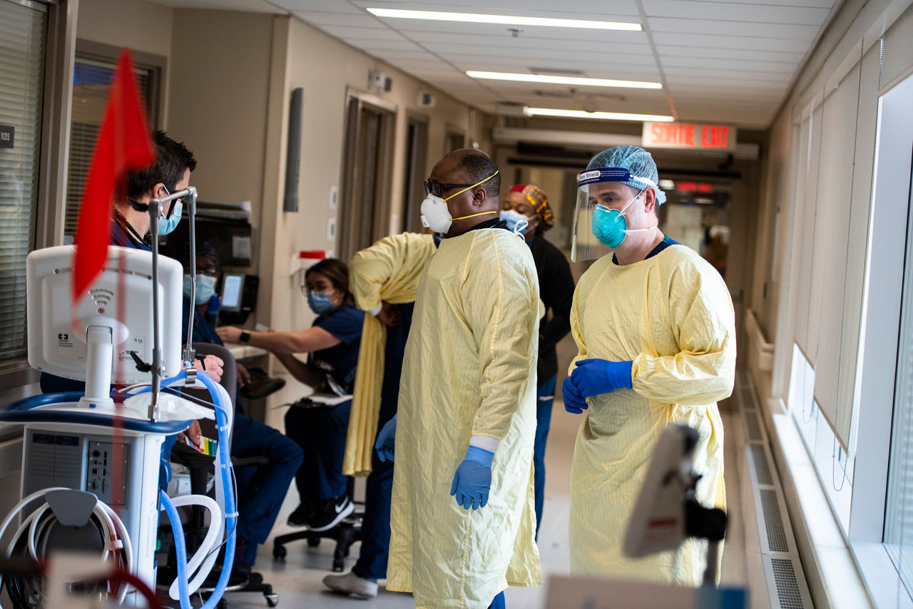 A group of physicians in the hallway of a hospital