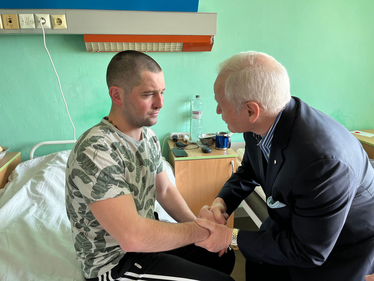 Dr. Peter Adamson shaking hands of patient