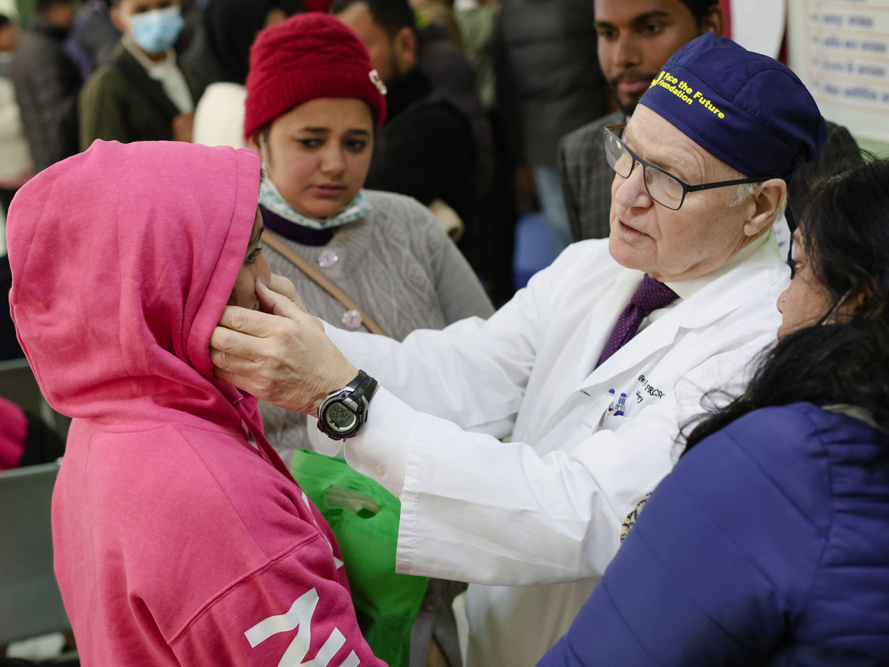 Dr. Peter Adamson examining pediatric patient